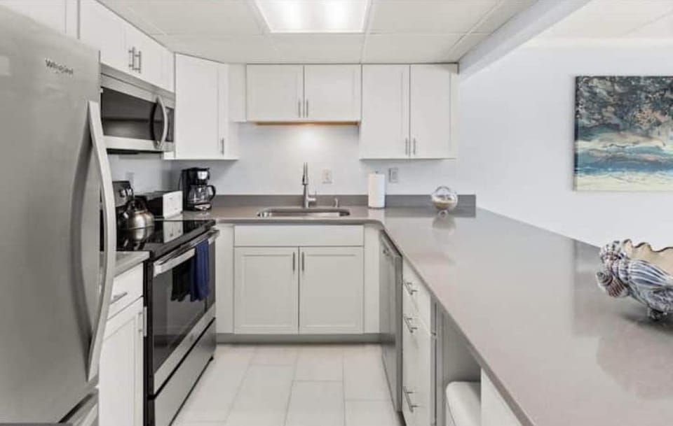 kitchen with large refrigerator, icemaker, and dish washer.  