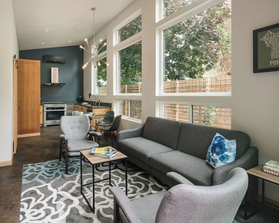 The living, dining, and kitchen area. Includes a sleeper sofa, Smart TV, and a Meile gas range.