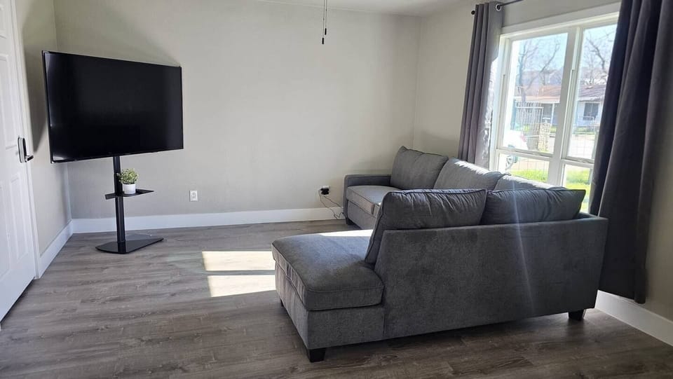 The living room is equipped with a television, providing a cozy space for guests.