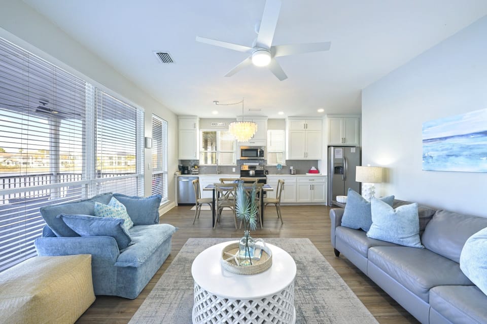 Living area with 55" Roku Smart TV and ample seating overlooks serene Four Prong Lake.