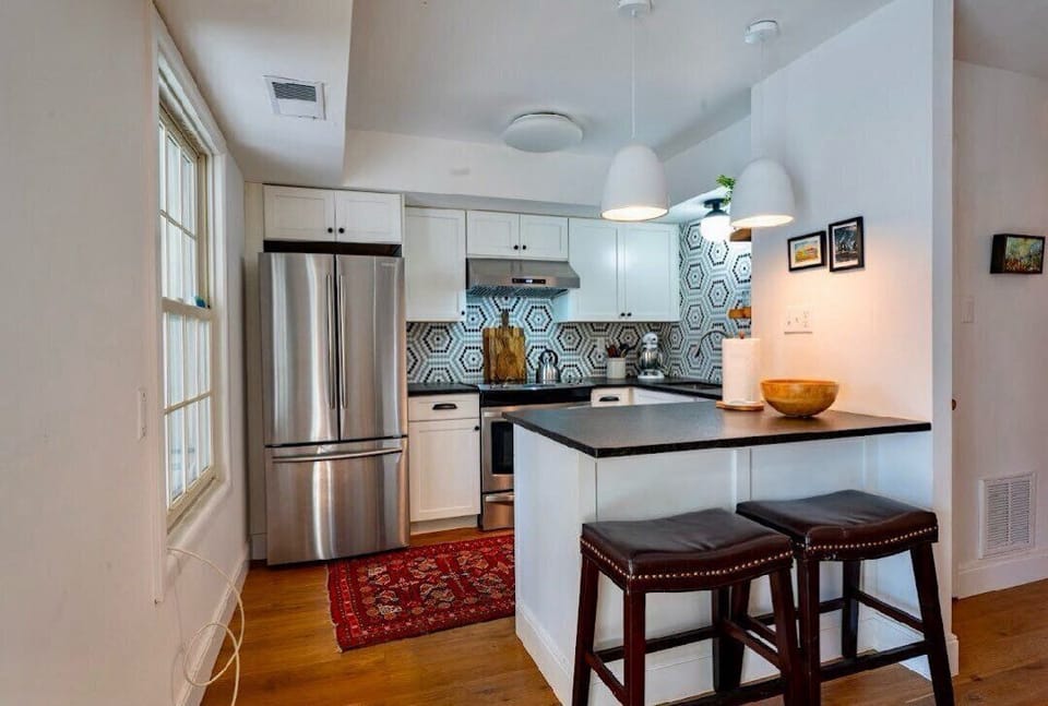 Kitchen with lots of counter space and seating at the bar.