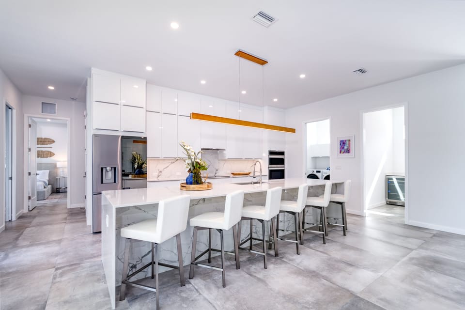 Start your day at the kitchen island breakfast bar—perfect for coffee, conversation and planning beach days.