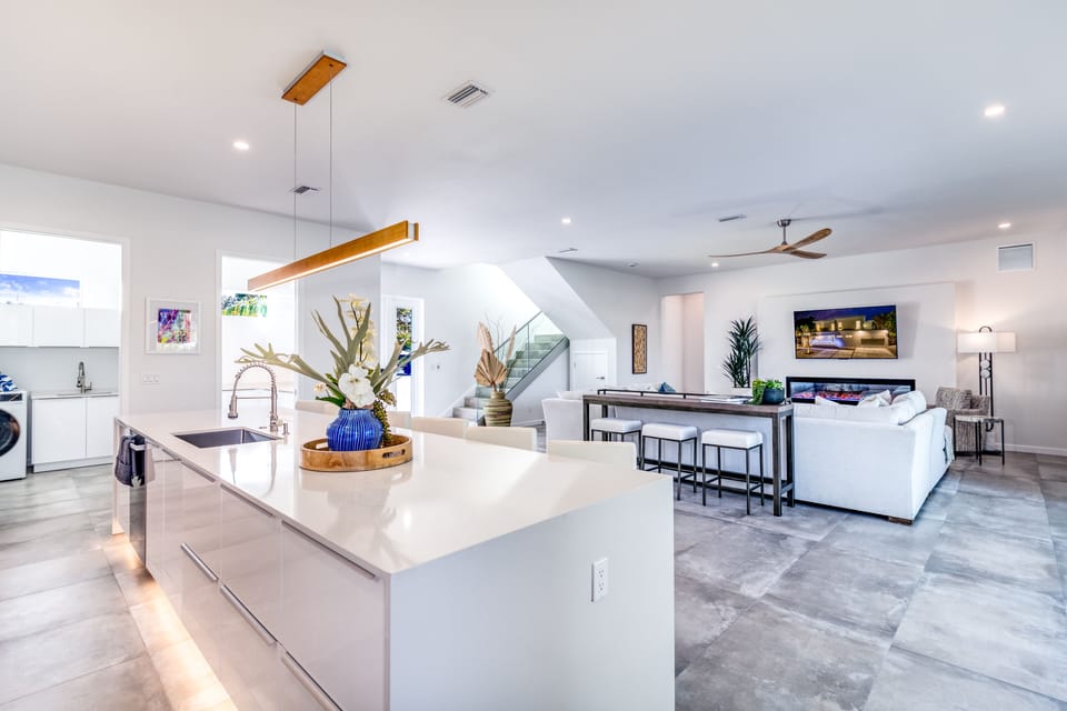Prep, pour, and gather at the sleek kitchen island, seamlessly connected to the living room.