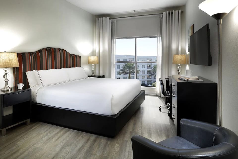 Unwind in crisp linens and bright, airy city views.