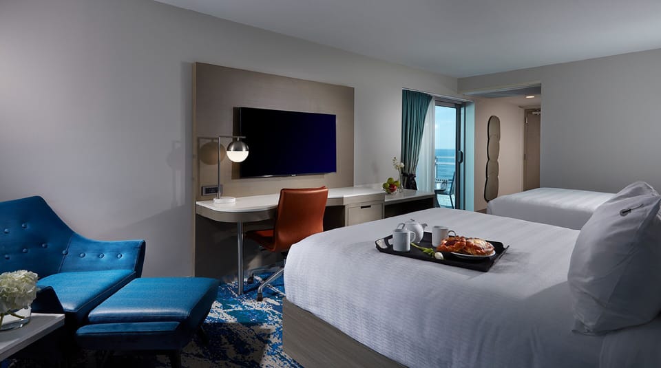 Enjoy breakfast in bed with entertainment and a sleek workspace.