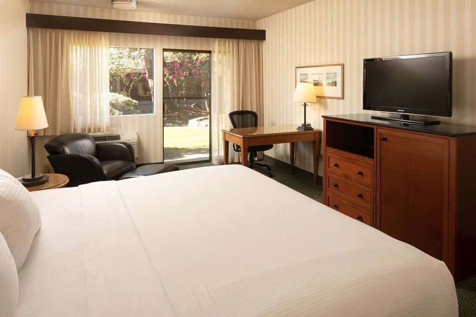 Unwind after meetings with streaming TV and a sunny workspace.