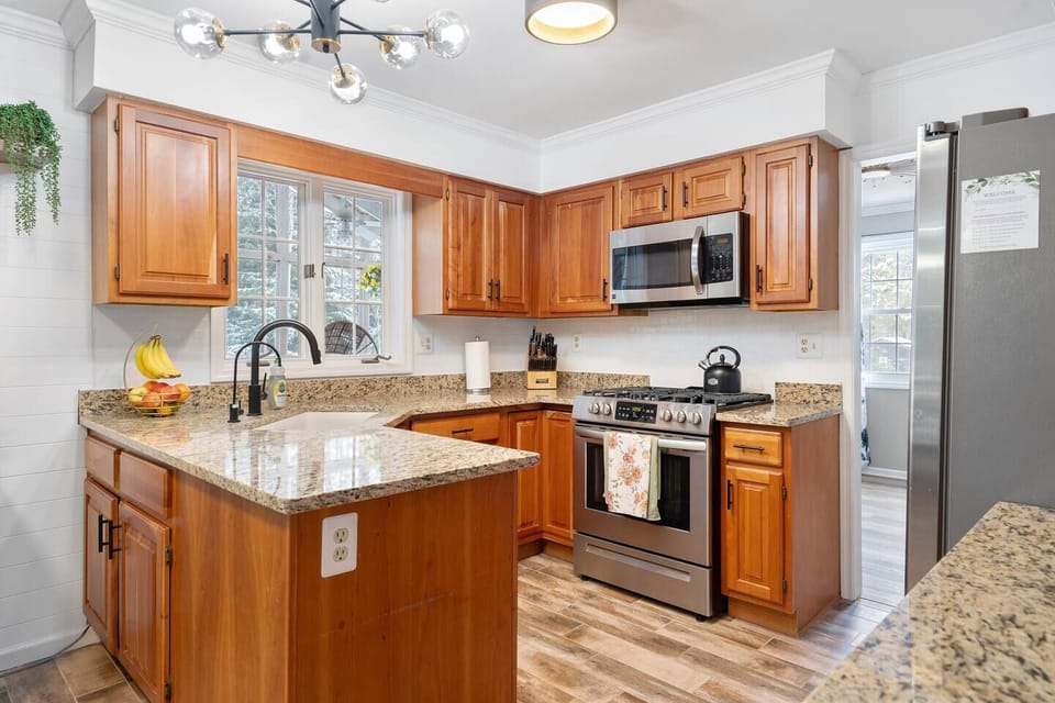 Shot of the kitchen.  It's fully stocked with pans, pots, and cooking utensils.  There's a nice assortment of spices and olive oil waiting for someone to cook up something that smells great.
