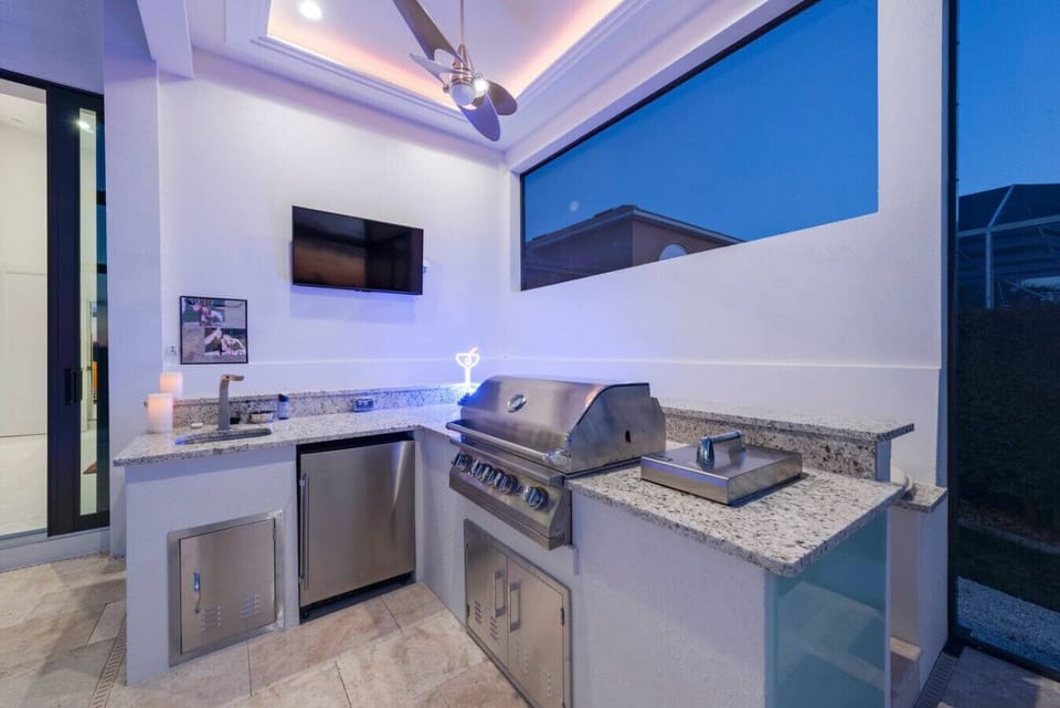 Outdoor kitchen with a built-in grill, perfect for evening barbecues.