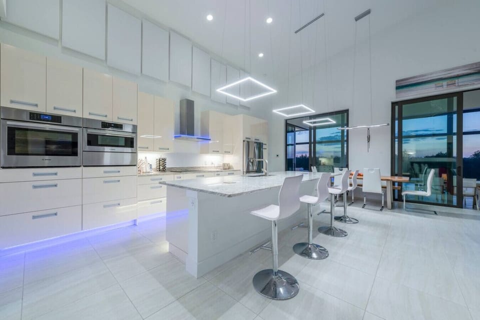 Modern kitchen with sleek appliances and island seating, perfect for entertaining.