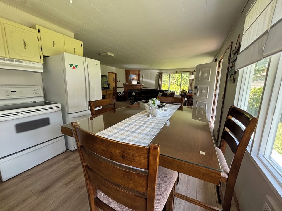 A wooden dining table set for four, adjacent to the living area.