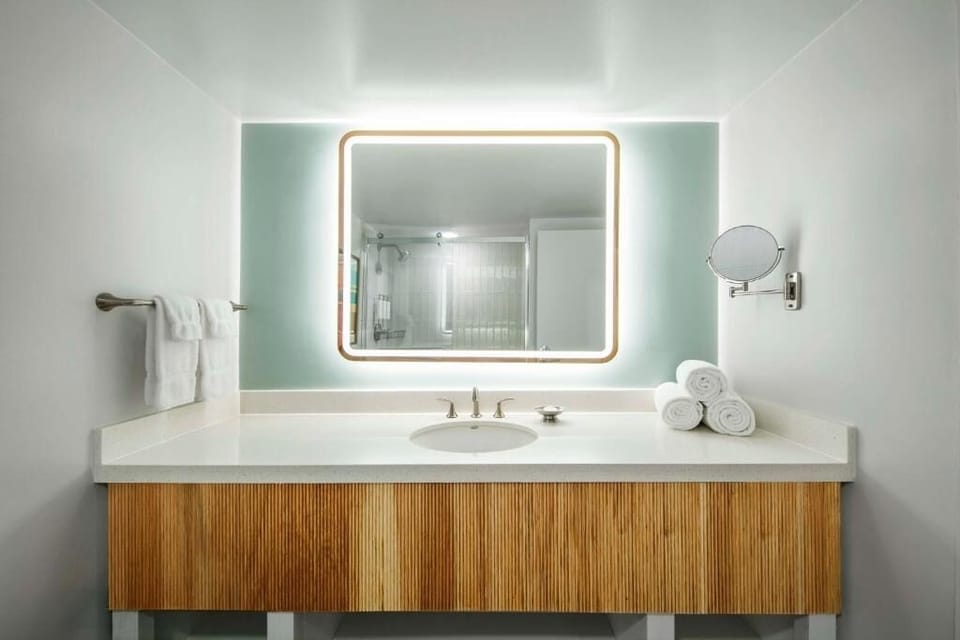 Refresh easily with a glowing mirror and spa-clean vanity.