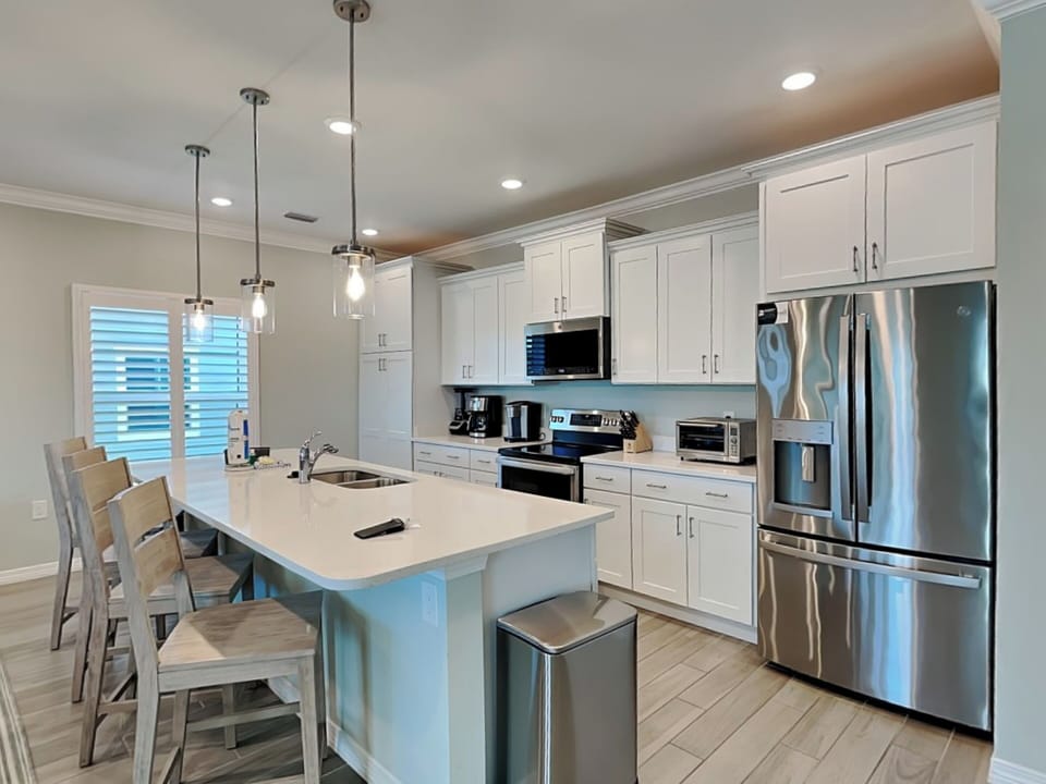Fully Equipped Kitchen with Stainless Steel Appliances and Bar Seating - Second Floor