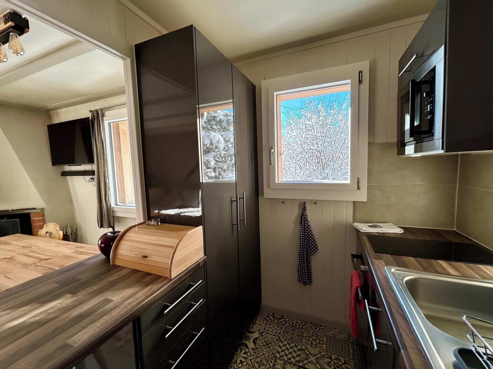 beautiful kitchen with views of white snow 