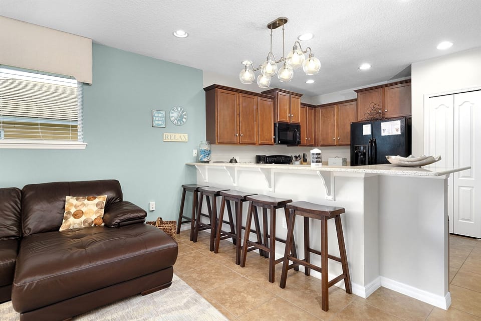 The kitchen counter has seating for five. 