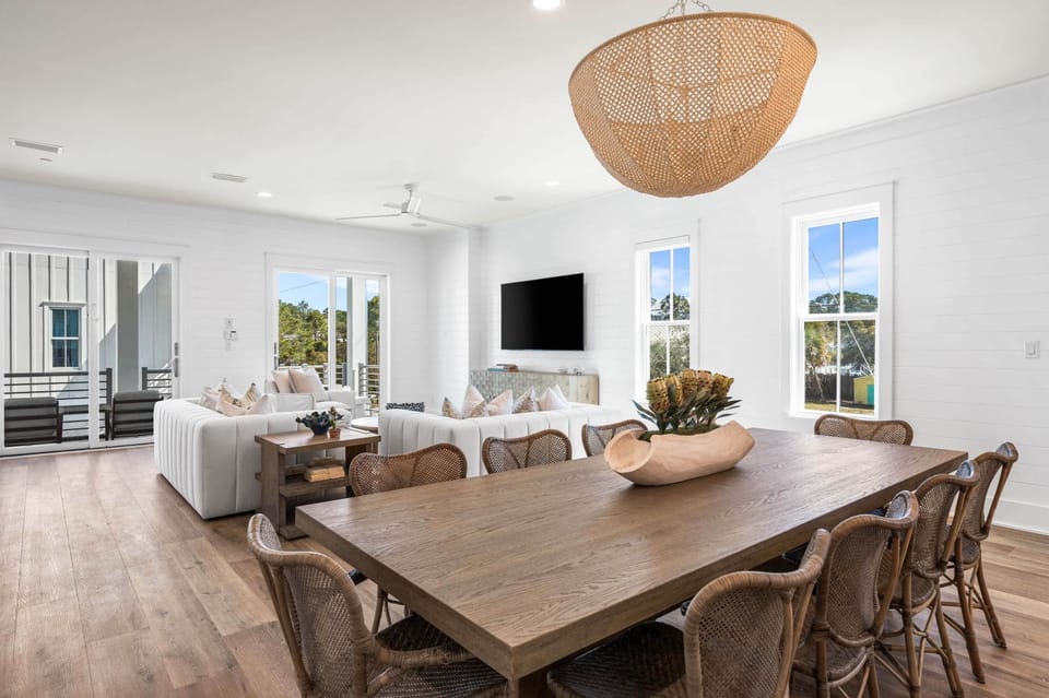 Main dining area with seating for 8 under the beach chandelier