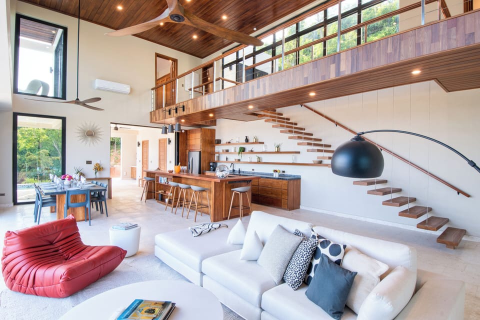 Floating staircase, kitchen and breakfast bar with access to the patio and pool