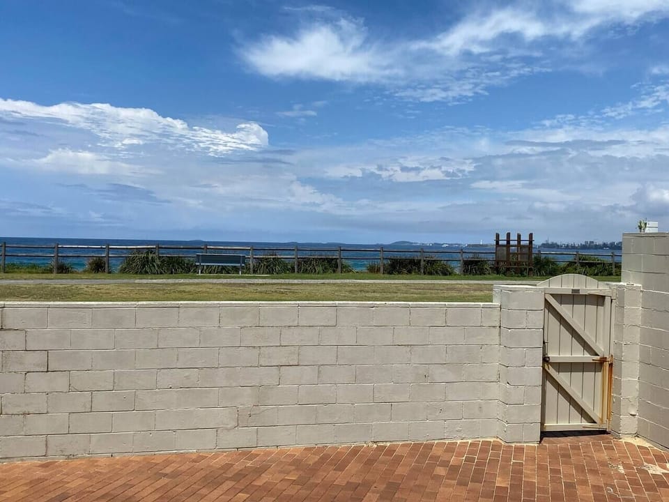 Enjoy direct access to the beach through the shared courtyard behind the property.