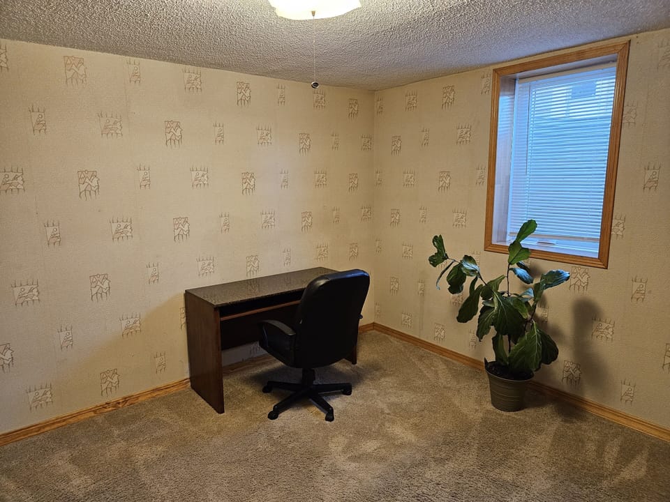 this is an office space with a desk and chair downstairs. 