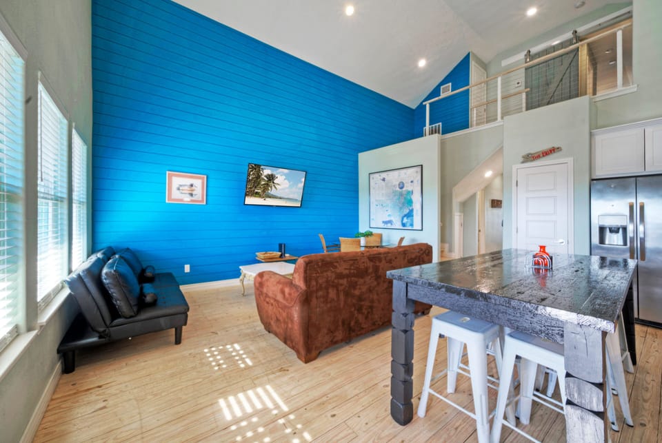 Blue accent wall adds a beachy character.