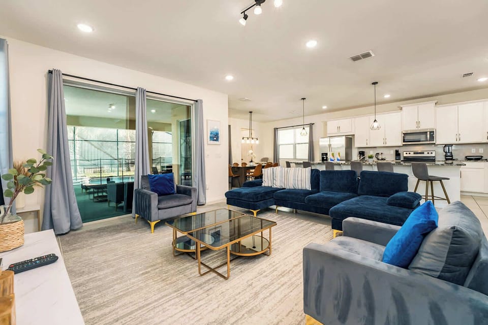 Elegant living space with plush seating and open kitchen, perfect for relaxation and entertaining.