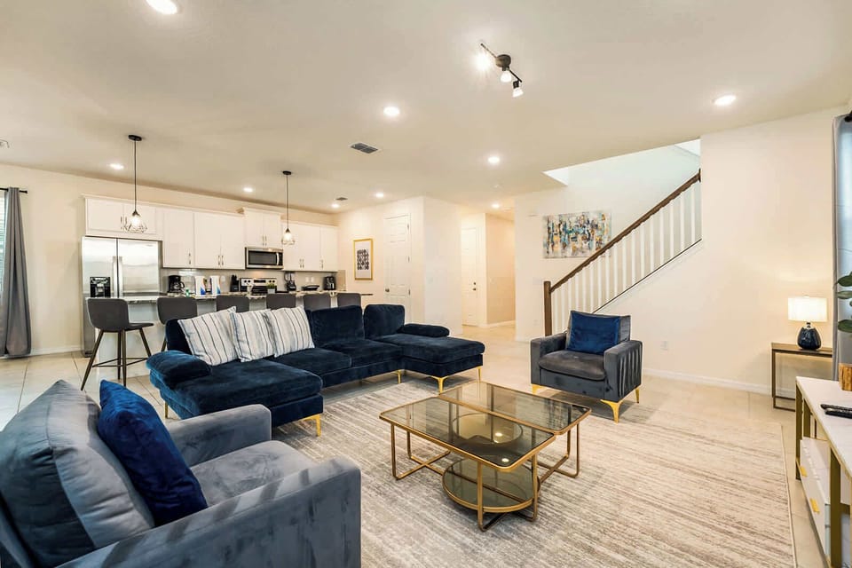 Elegant and spacious living area with plush seating and a modern kitchen, perfect for relaxation and entertaining.