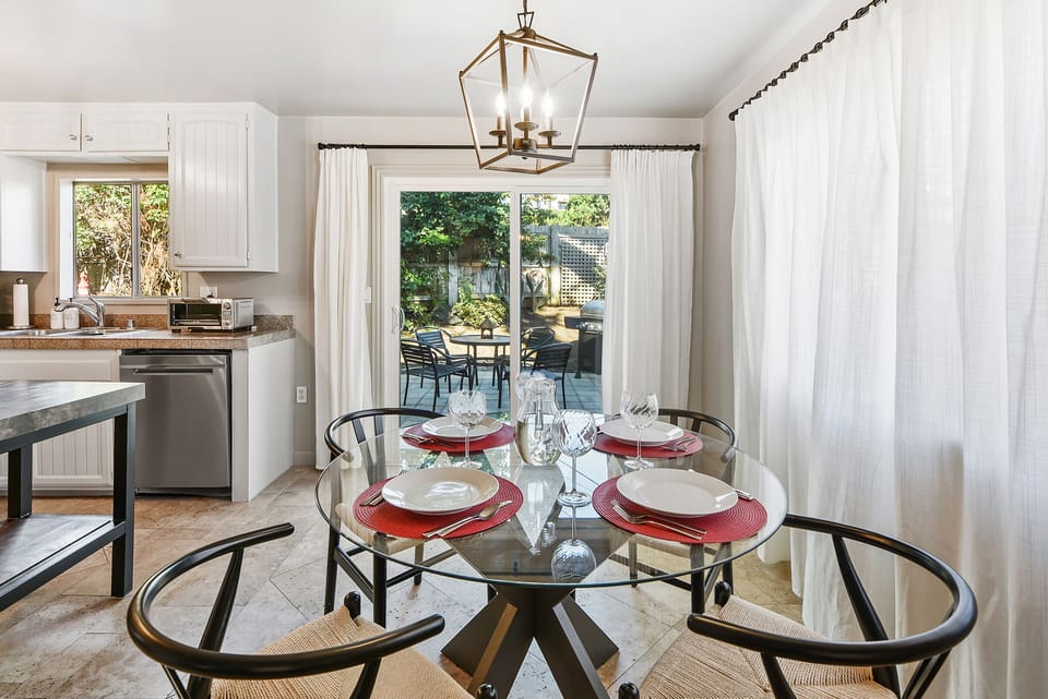 This glass dining table seats four and provides easy access to the patio for indoor-outdoor living.