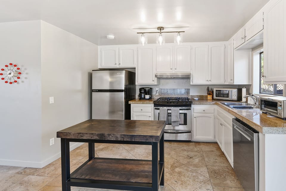The kitchen offers plenty of counter space and white cabinetry to store all your cooking essentials.