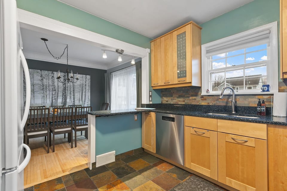 Your bright kitchen flows into the dining area, perfect for preparing meals and gathering together.