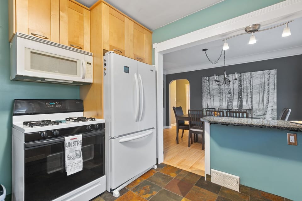 Your spacious kitchen features modern appliances, granite counters, and opens seamlessly to the dining area for memorable meals together.