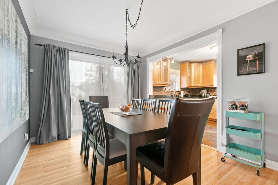 Your elegant dining space features a spacious table for memorable meals, with an adjoining kitchen for easy entertaining.