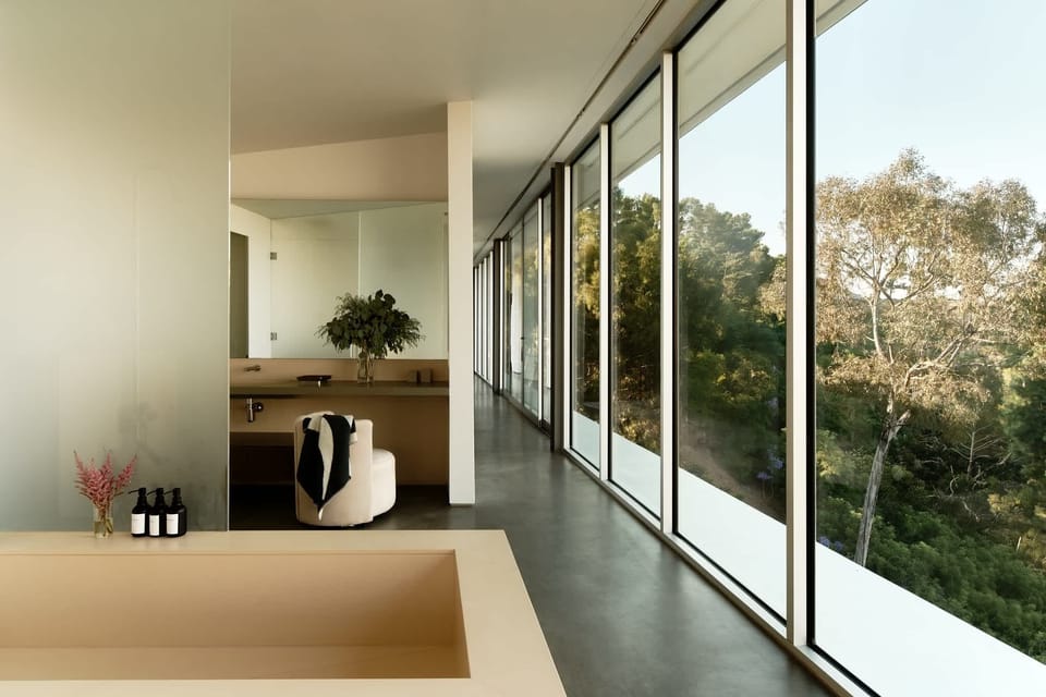 Floor-to-ceiling windows offering panoramic city views.