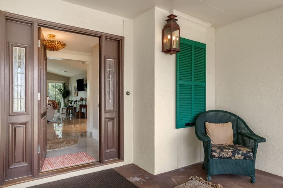 The entrance of the house provides additional seating options for guests to relax and unwind.