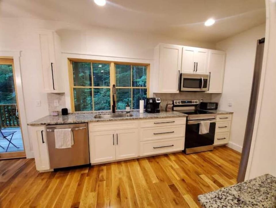 Full kitchen complete with everything you need. A gas grill is on the balcony.