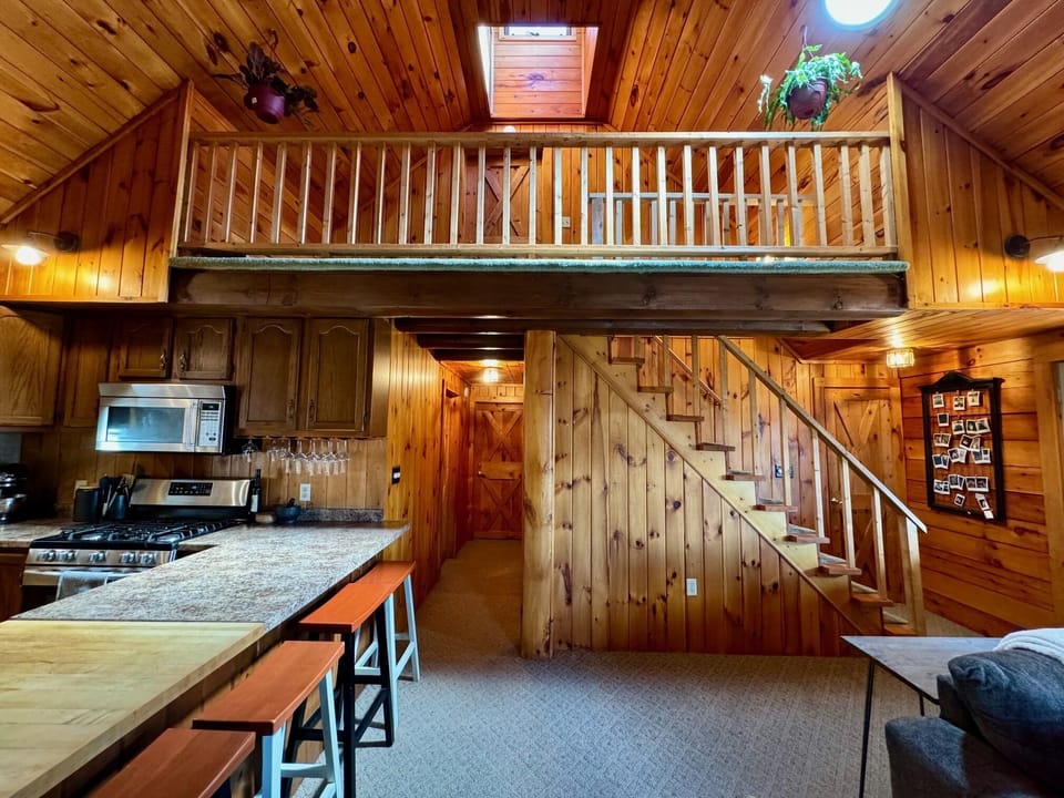Stairs leading to upper level bedroom, hallway to other two main level bedrooms