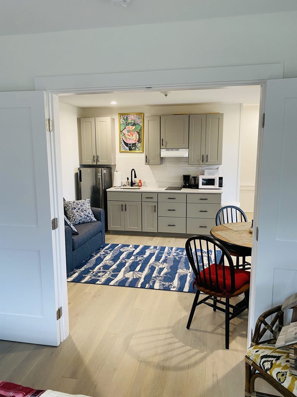 kitchenette with electric stove top, fridge, microwave, kettle, coffee maker