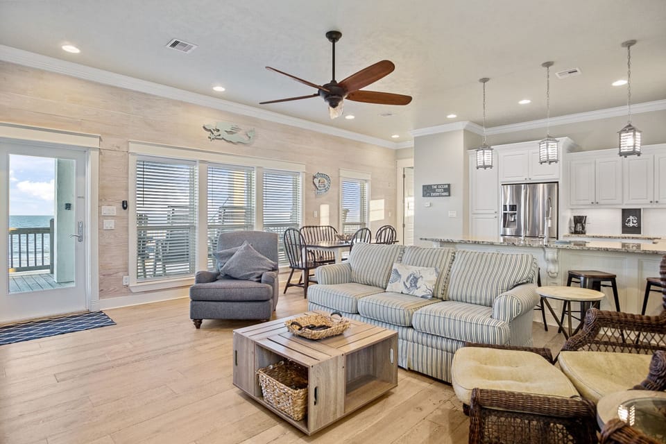 Beach Breeze Living Area: Plenty of seating for guests, with tons of windows to capture the views. 