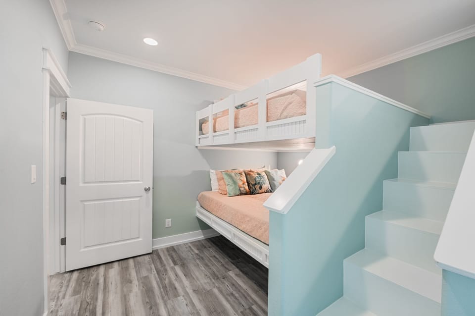 Feeling TipSea Bedroom 2: Unwind in luxury in this beautifully appointed bedroom, showcasing four custom-built queen over queen bunk beds, thoughtfully designed to maximize space and ensure a restful night's sleep for all guests.
