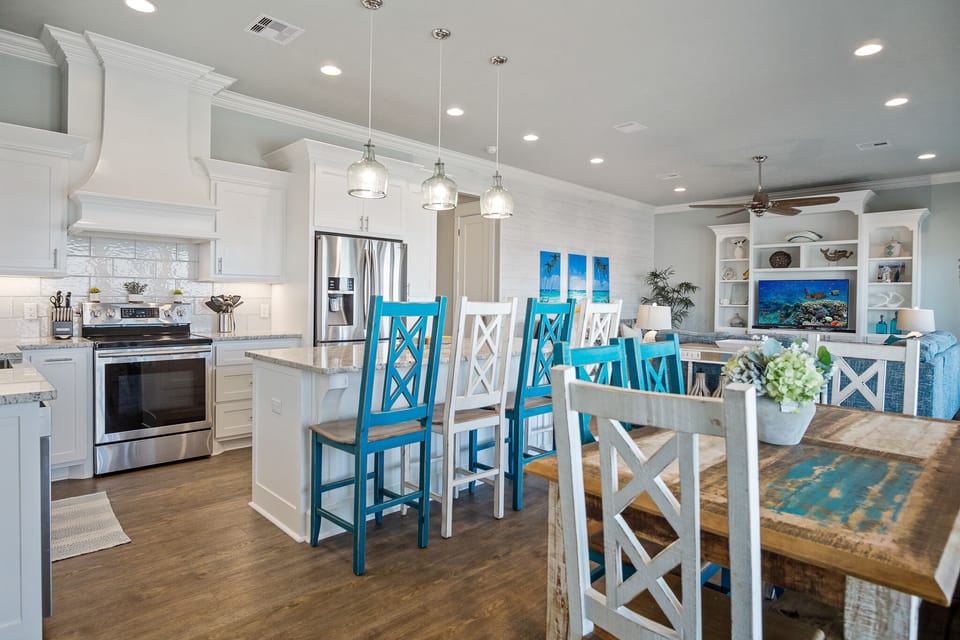 Sandy Toes Kitchen: Delight in the seamless blend of form and function in this designer kitchen, featuring custom cabinetry, integrated storage solutions for effortless entertaining.