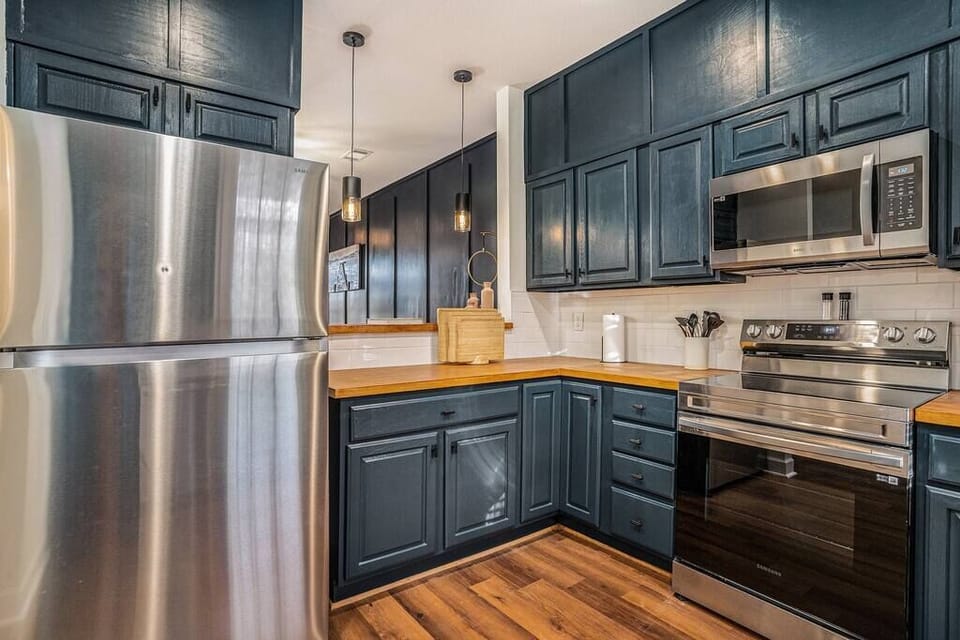 KITCHEN OVERLOOKING BAR AREA AND LIVING ROOM