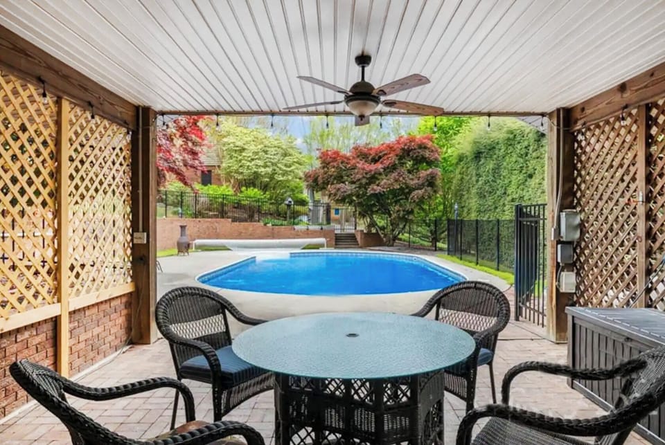 Sparkling pool area with tables for dining & leisure.