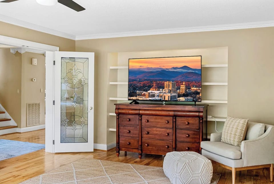 Entertainment area with TV on a stylish wooden console.
