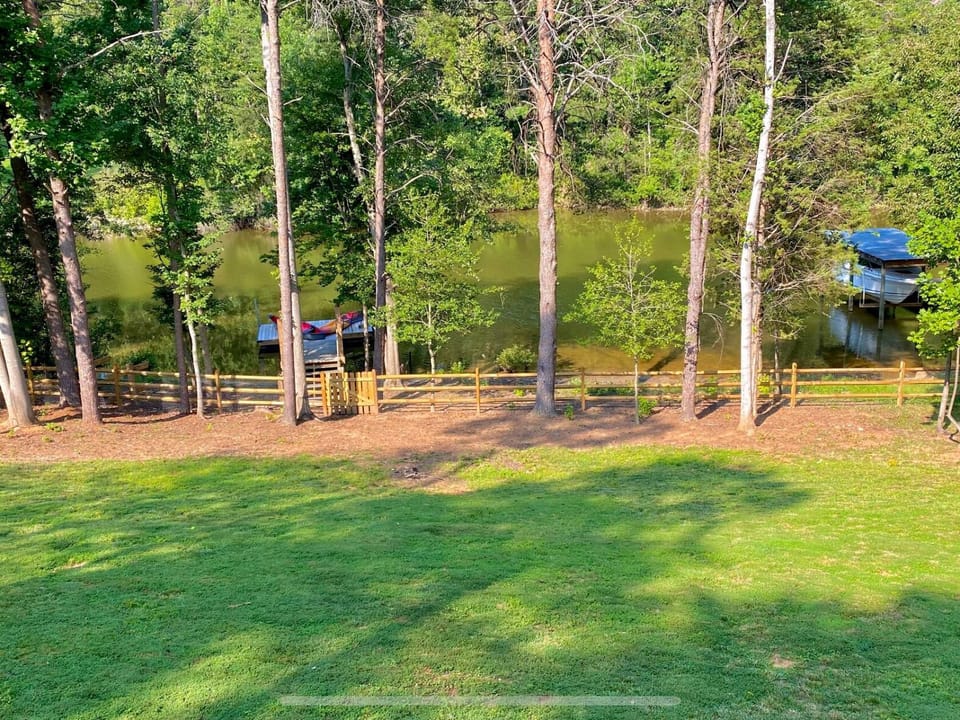 Lake view fenced in back yard and dock
