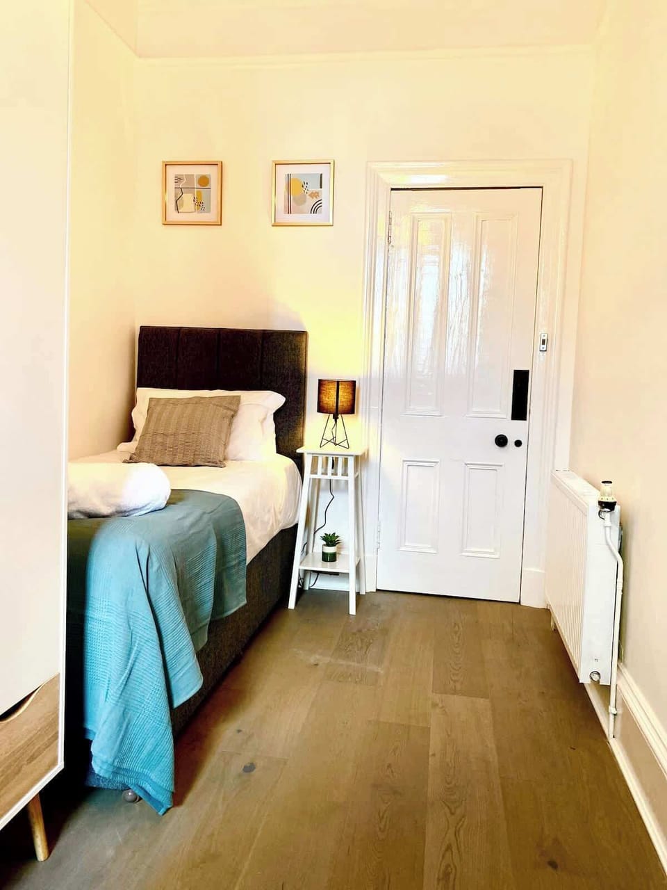 Comfortable bedroom with 2 single beds, fresh linens, soft lighting, and a relaxing atmosphere for a restful stay.