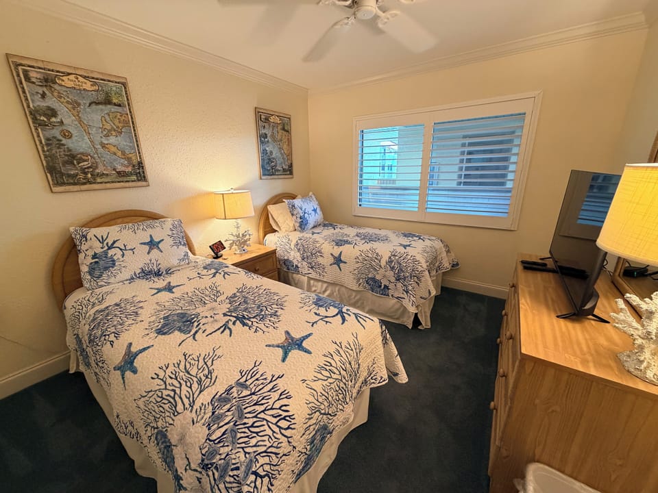 You'll sleep soundly in this coastal-themed twin room, where ocean-inspired bedding, vintage map art, and soft lamplight create a relaxing retreat after your day exploring the coast.