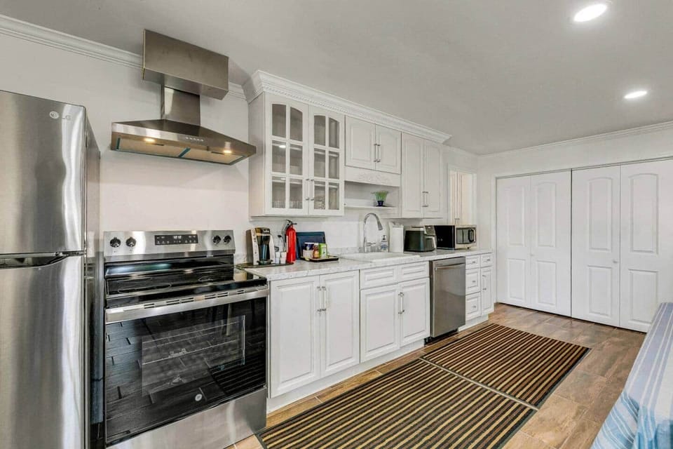 Full kitchen with refrigerator, stove and oven, dishwasher, microwave, coffee