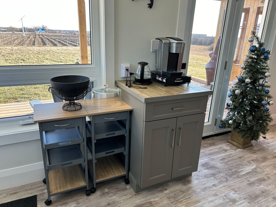Serving tables, Keurig & kettle, phone charging station, cupboard facing south