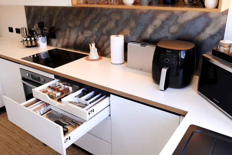Cooking utensils, dinnerware and cutleries in smart storage and soft close drawers
