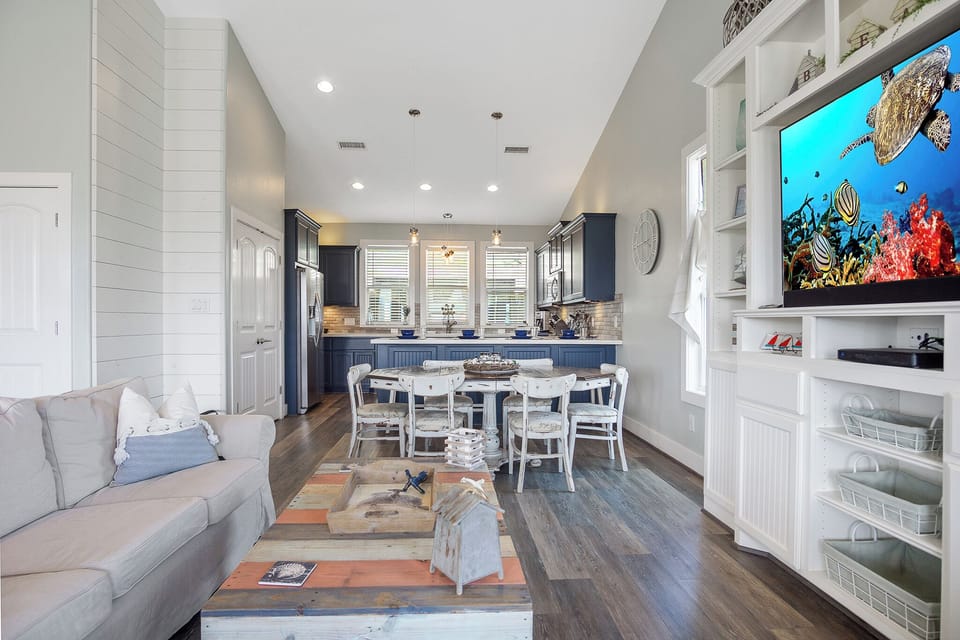One Love Living Room: Indulge in coastal luxury in our living space, boasting a custom-built media center, cozy seating perfect for conversation, watching a movie or taking a nap. 