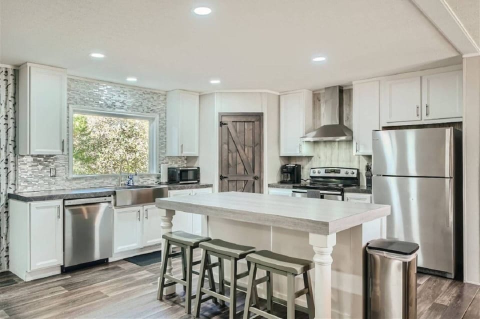 Modern Kitchen with stainless steel appliances and bar stools