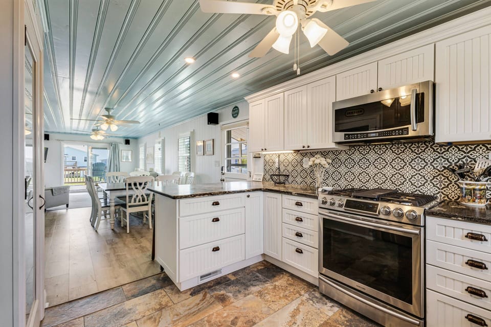Enter by the kitchen bar, to the open concept kitchen/dining/living areas.